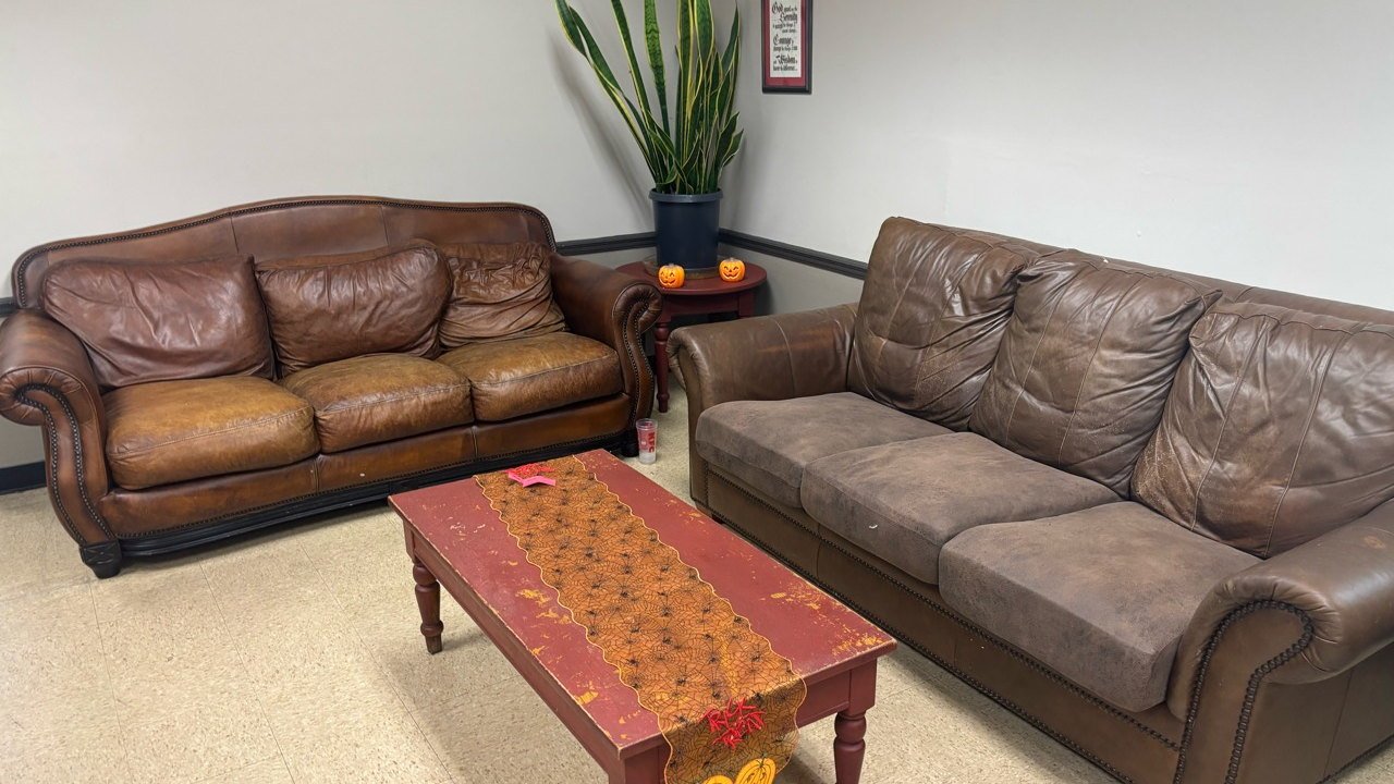 The current clubhouse lounge with two couches and a coffee table